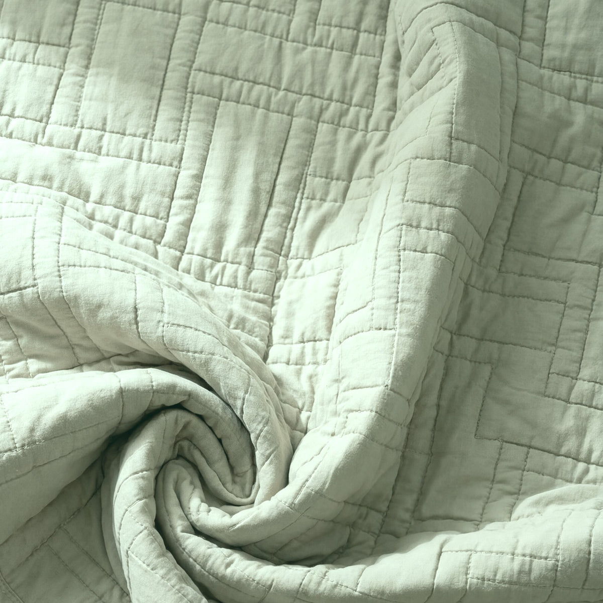 The Luxor Heritage Grid Quilt in Sage Leaf: fabric close-up, color preview